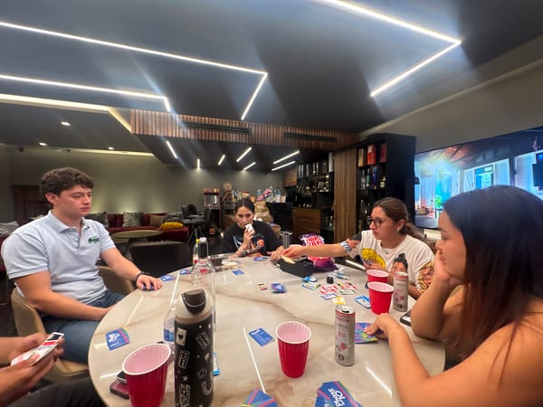 Friends play Phase 10 card game in Mexico morning