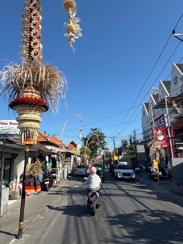North Kuta street traffic and penjor decorations on a sunny morning