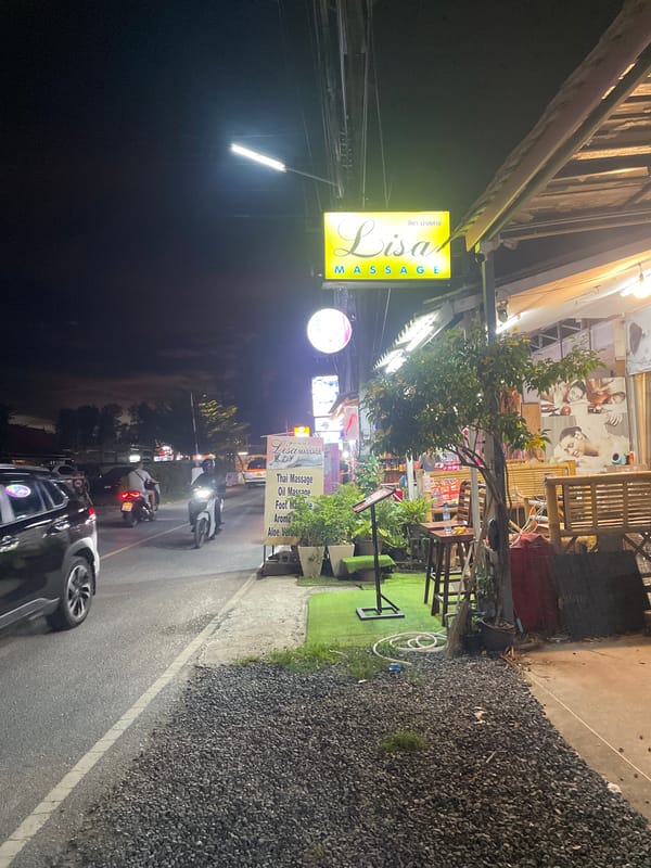 Illuminated massage parlor observed during nighttime in Choeng Thale