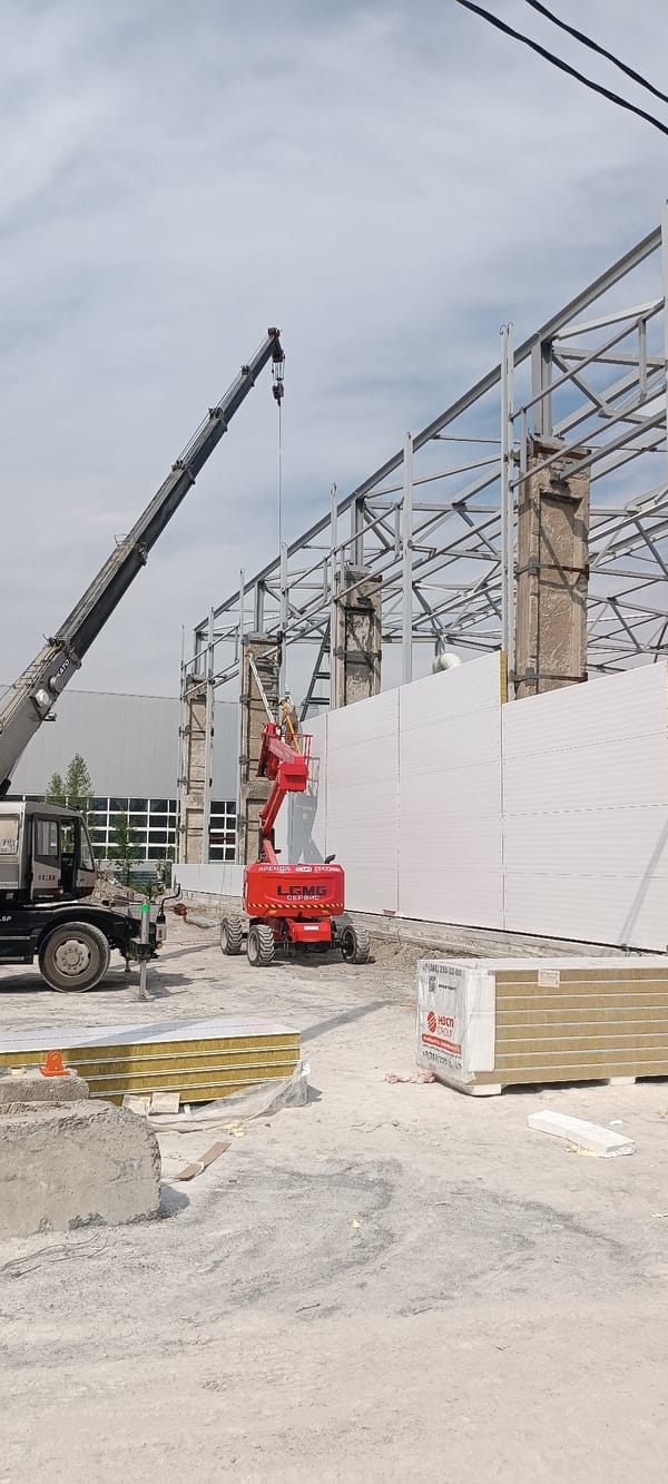 Steel-framed building takes shape at active urban construction site