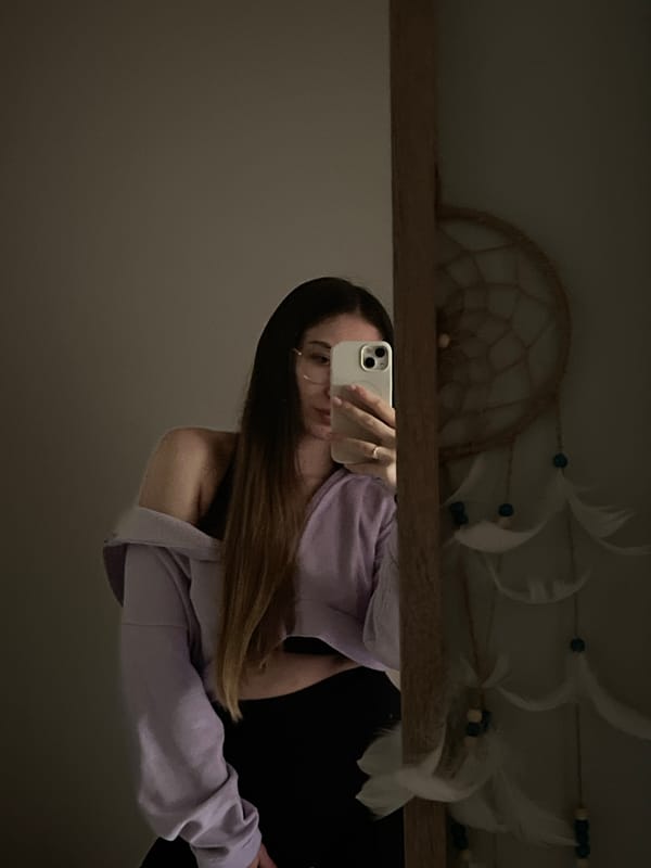 Woman Takes Mirror Selfies in Purple Sweatshirt