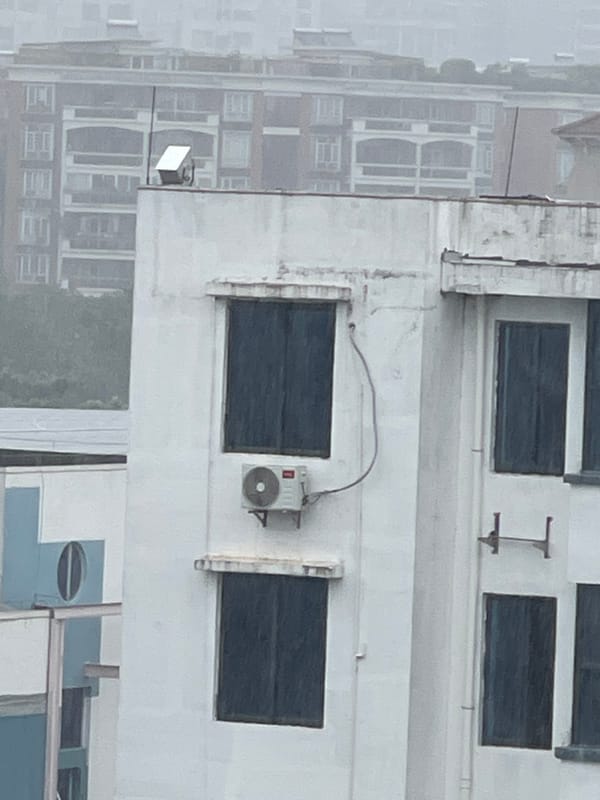 Rainy rooftop views across Panyu District's urban residential fabric