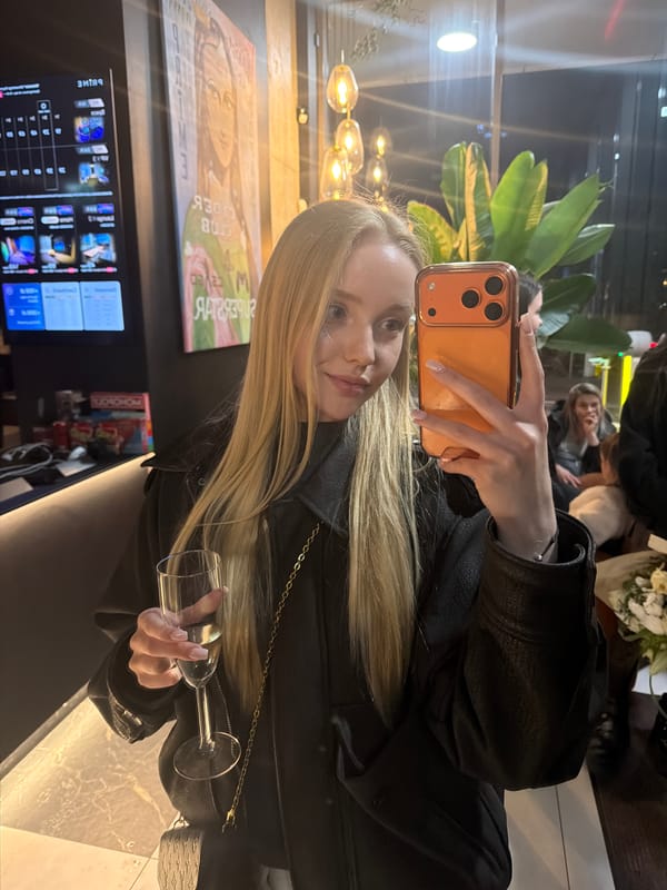 Woman takes selfie with wine at upscale lounge