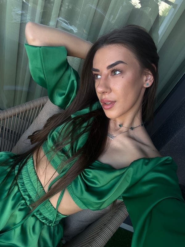 Relaxed balcony moment in Sofia, green satin outfit