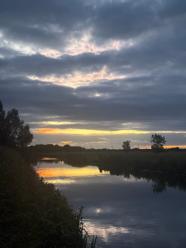Dusk river reflections under stormy skies in Peterborough