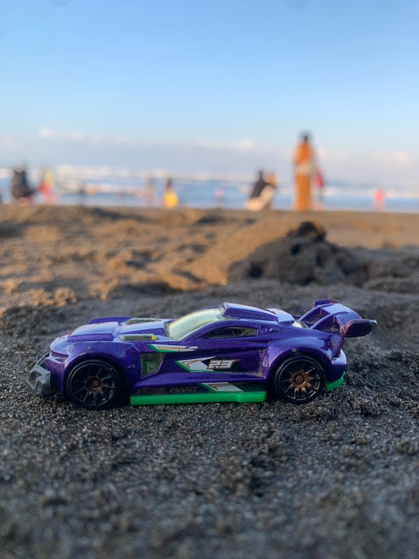 Hot Wheels toy car photographed on Indonesian beach