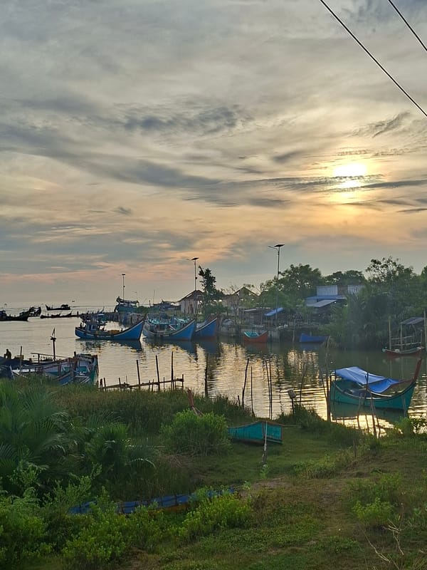 Dawn harbor scene with fishing boats in Keude