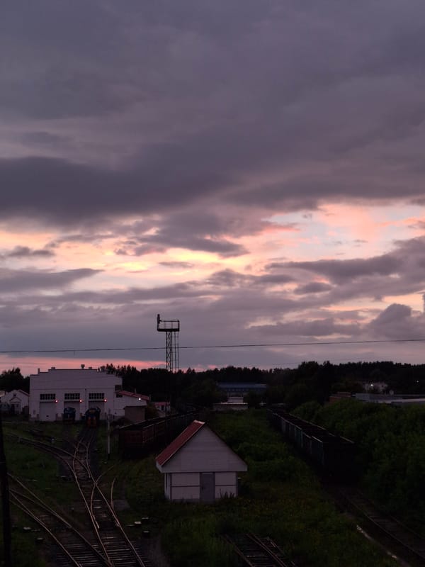 Rainy dusk settles over Chaikovsky's streets and rail yard