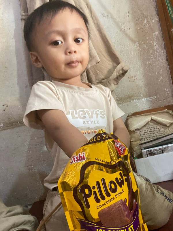 Child drinks fresh coconut at a Ta', Indonesia market stall