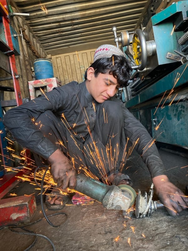 Young craftsmen work in Kandahar metalworking shops during morning hours