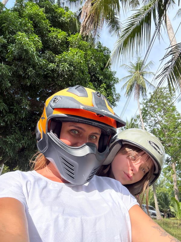 Scooter selfie on a palm-lined road in Ko Samui