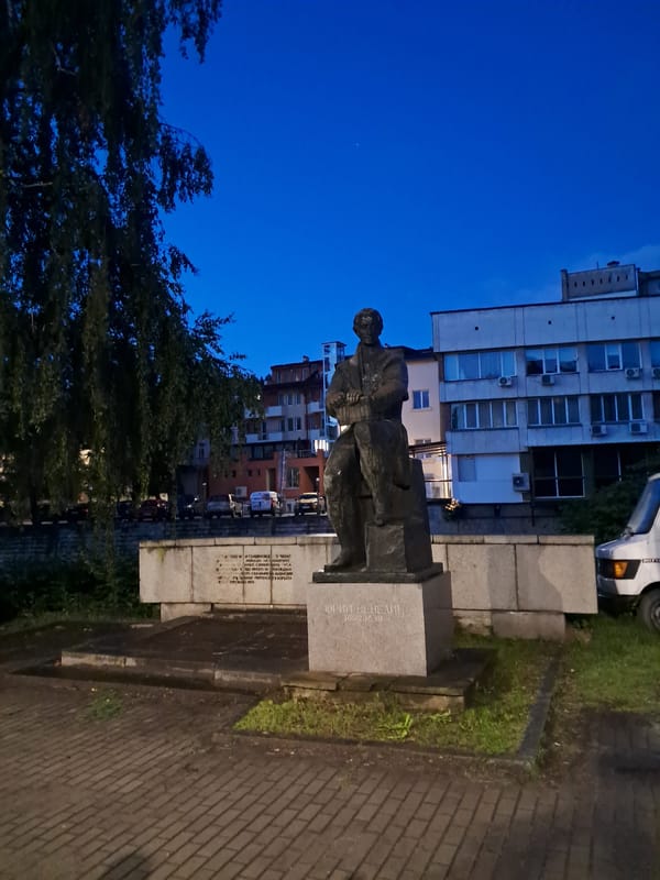 Bronze statue of historical figure observed in urban setting