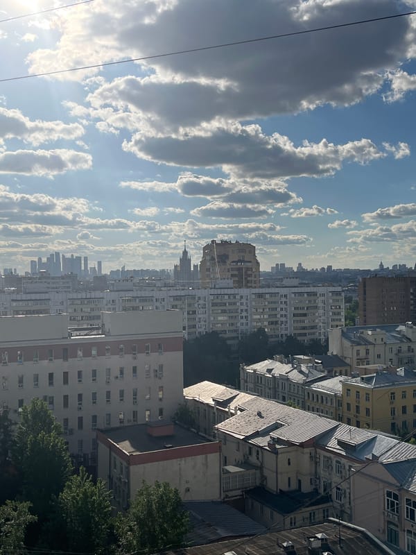 Cityscape viewed from elevated position under partly cloudy skies