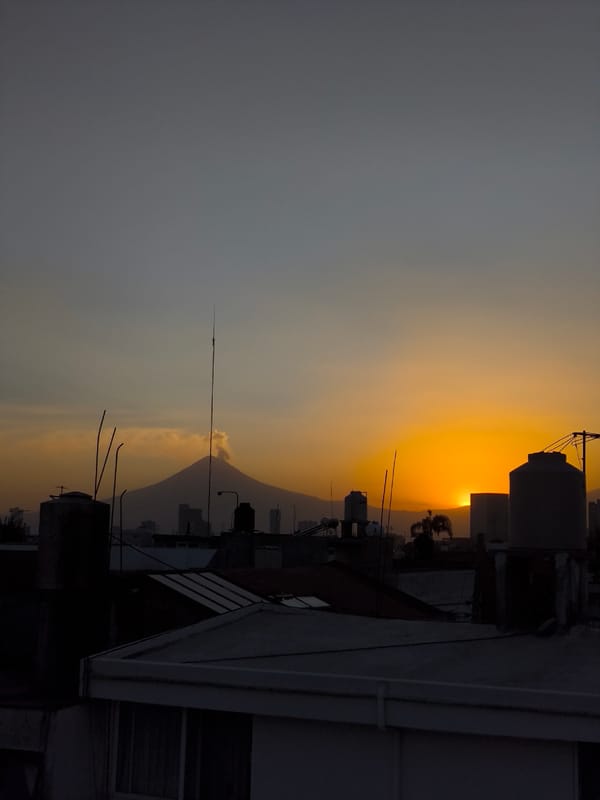 Sunset view captured from Puebla rooftop showing Popocatépetl volcano