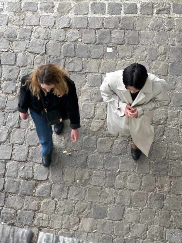 Two women observed on cobblestone street near Paris Panthéon