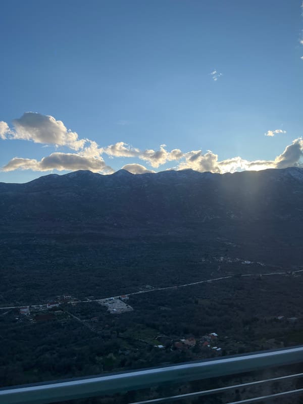 Sunlight breaks through clouds over Croatian mountain settlement