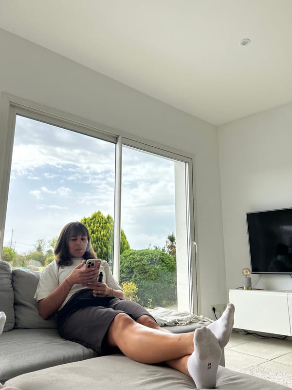 Woman relaxes on patio in Veauchette, France morning