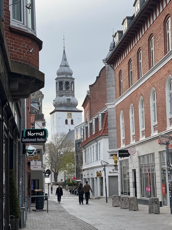 Tourist documents spring afternoon walk through historic Aalborg streets
