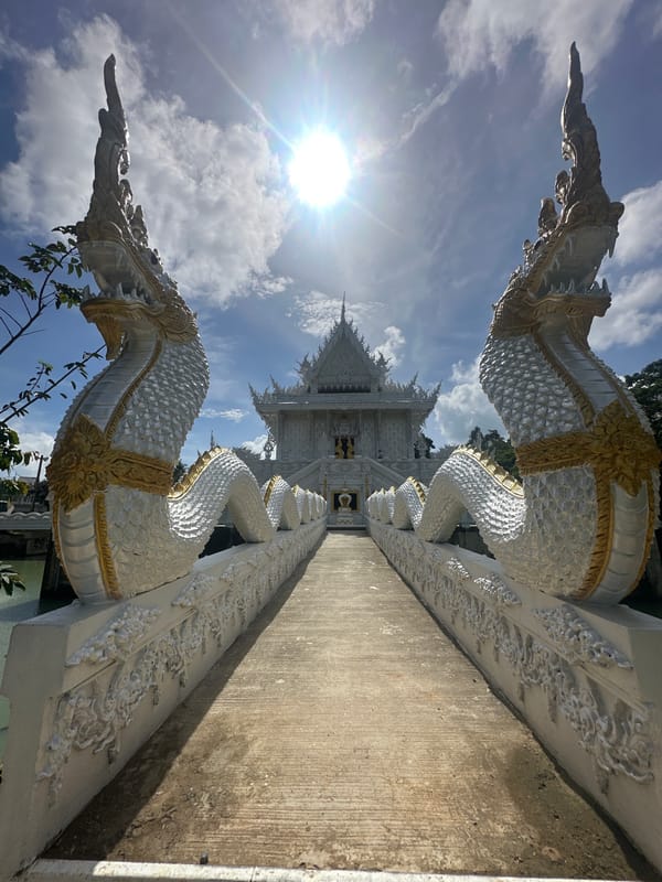 Ornate white temple in Thep Krasatti on a sunny morning