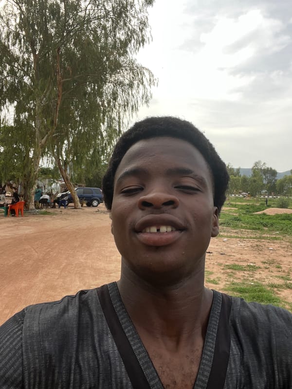 Young man takes selfie near gathering in Kporva, Nigeria