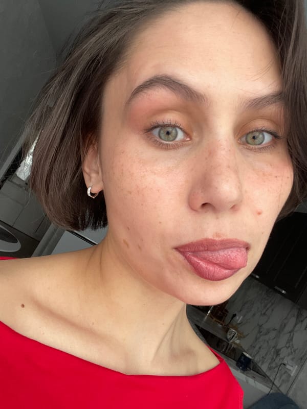 Woman holds banana to cheek in Izhevsk