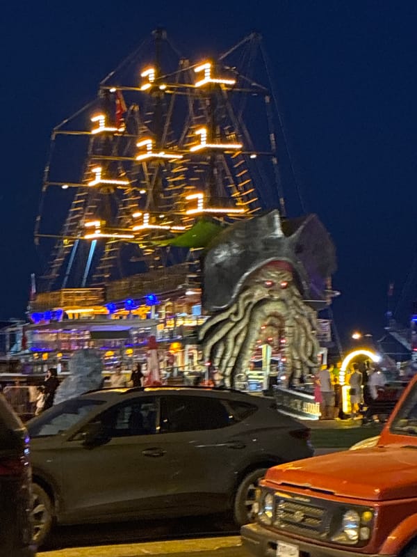 Alanya's waterfront at night: pirate ship, restaurants, and waterfalls