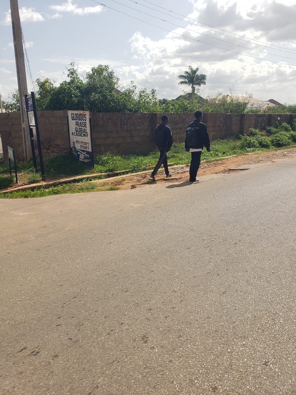 Pedestrians walk through Gura Top neighborhood streets
