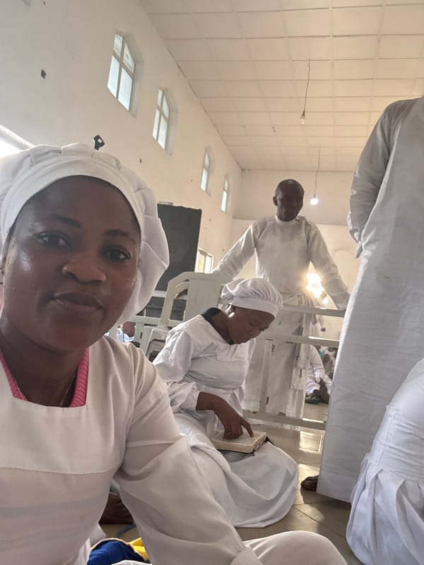 White-robed group gathers in church interior, selfie taken