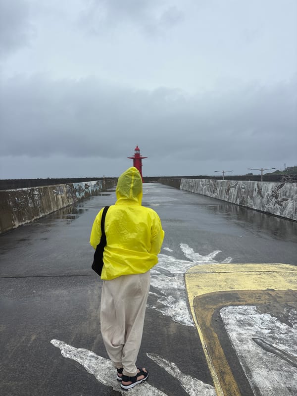 Rainy day at Seogwipo's red lighthouse pier, Jeju Island