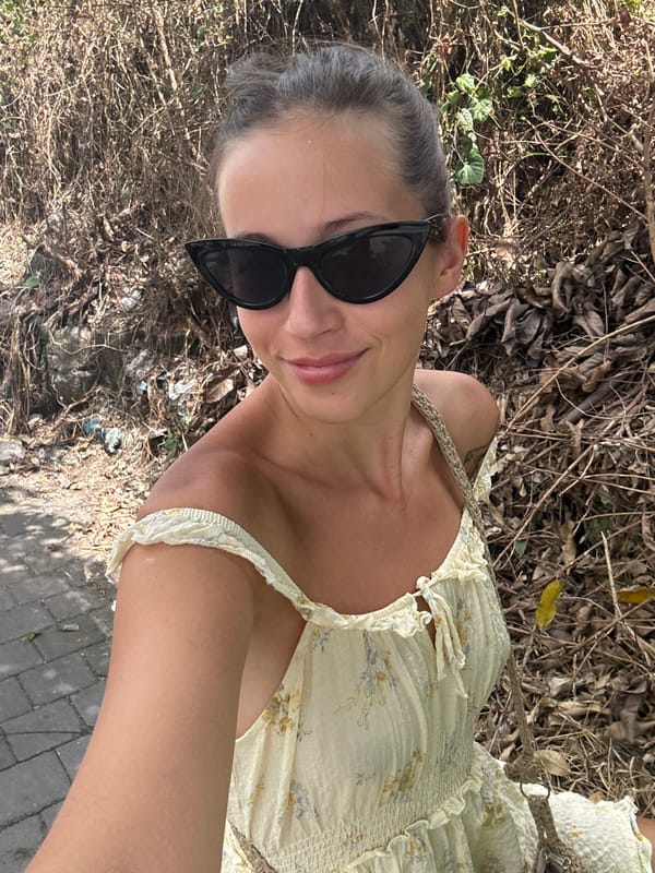 Woman in floral dress photographed outdoors in Mengwi, Indonesia