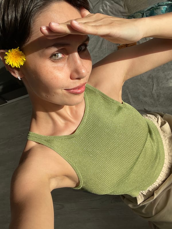 Woman photographs herself with dandelions in Izhevsk, Russia