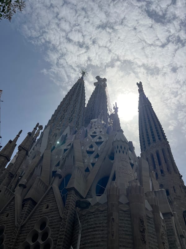 Sagrada Família spires and street music on a Barcelona morning