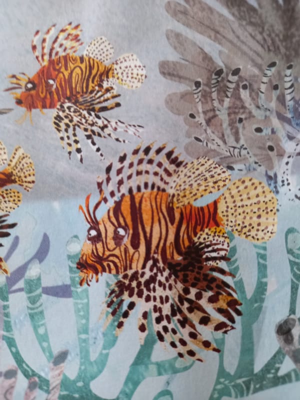 Colorful reef fish illustrations on fabric in Baan Mae Nam