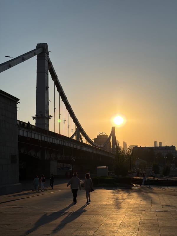 Sunset silhouettes city bridge in golden evening sky