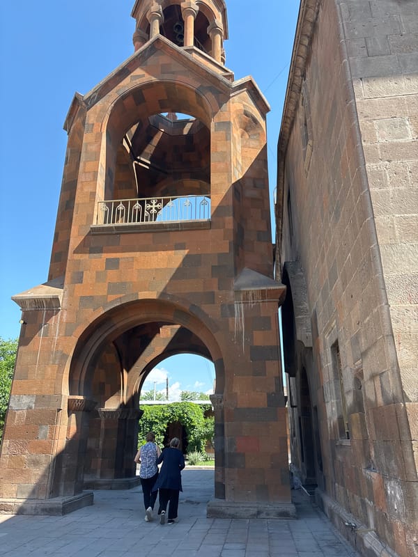 Morning documentation of Armenian religious site architecture and ceremonial candles