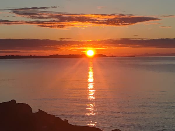 Baltic Sea sunset from Tallinn coastline with ferries and skyline