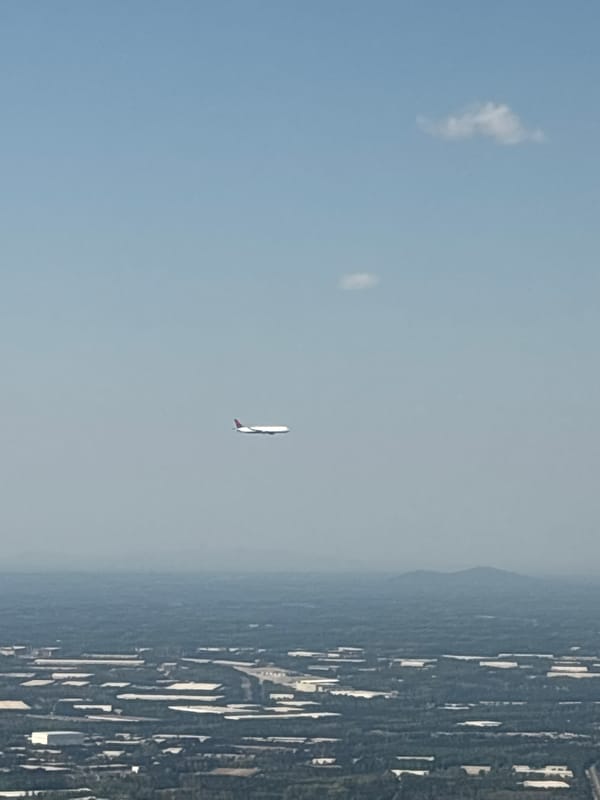 Passenger captures aerial views of urban landscape during evening flight
