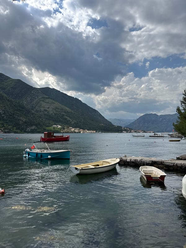 Peaceful harbor activity observed in Dobrota, Montenegro waterfront
