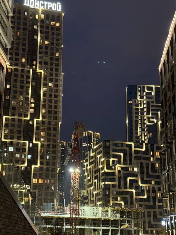 Nighttime urban photography session captures illuminated buildings in Khimki