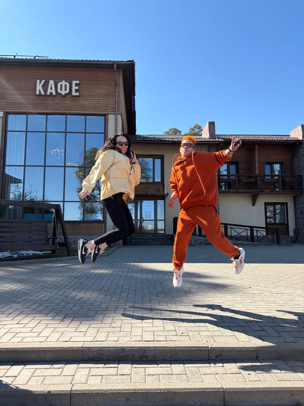 Two people pose playfully outside cafe in Votkinsk