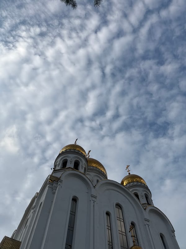 Golden domes, stormy skies, and a quiet bench in Russia