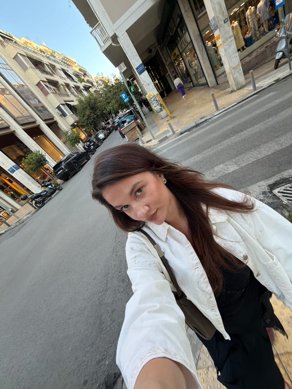 Woman documents Athens street walk with selfie