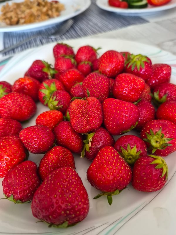 Fresh strawberries served up with an anime mug on the side