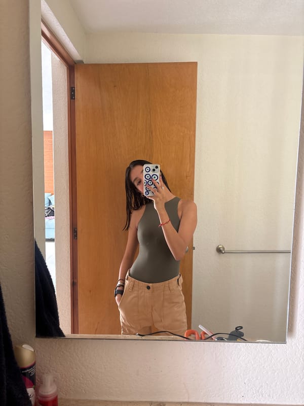 Person photographed in mirror reflection in Puebla home