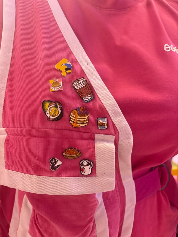 Food-themed enamel pins spotted on pink garment in Moscow