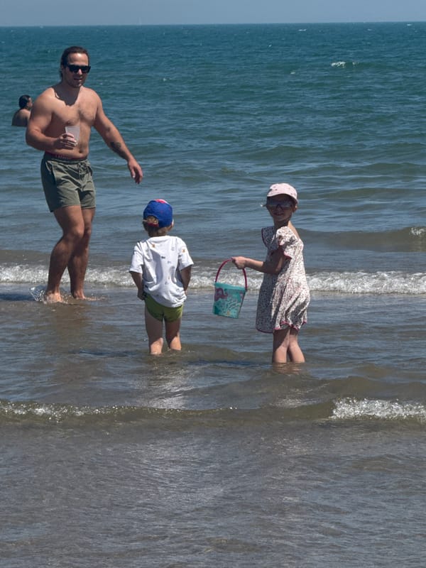 Family enjoys sunny beach day in Valencia, Spain