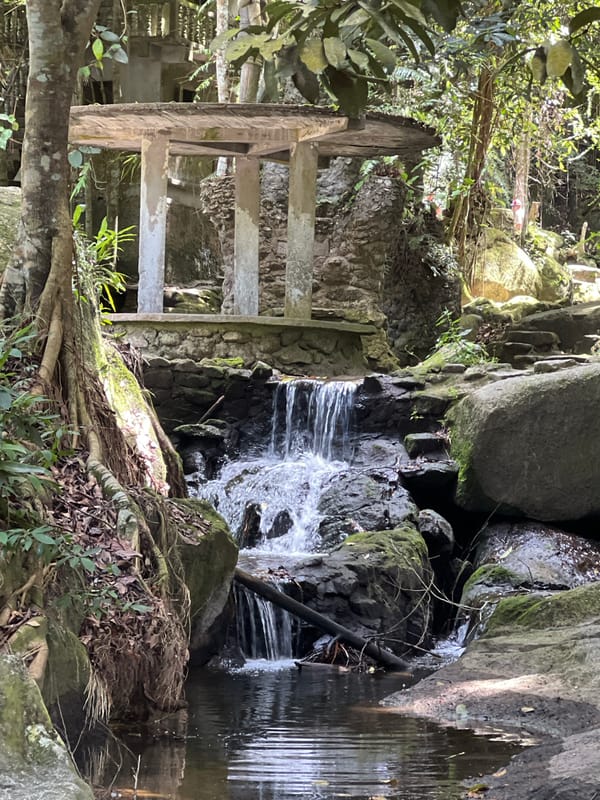 Mossy temple statues and jungle waterfall on Ko Samui