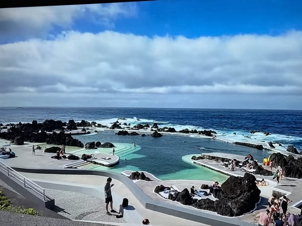 Coastal Madeira: cliffs, dark sand beach, and the Ronaldo Museum