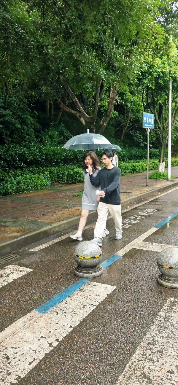 Couple walks with clear umbrella during nighttime rain in Chongqing