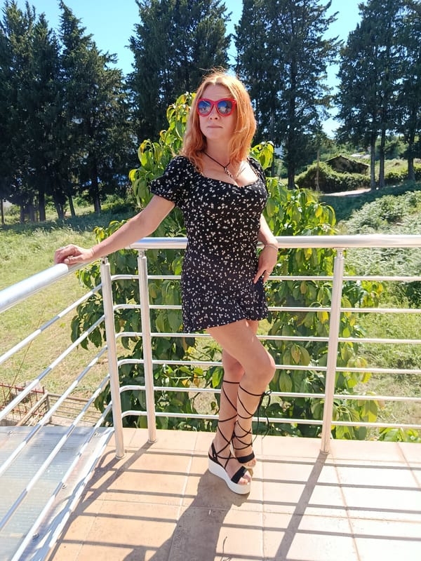 Woman poses for photos on Montenegro balcony overlooking Bay
